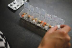 Woman organizes her medication calendar for addiciton and mental health
