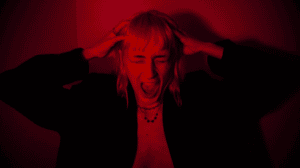 Woman in red room screaming