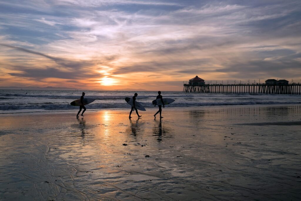 an image of people walking on the beach going to a huntington beach rehab
