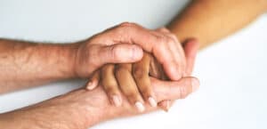 an image of people embracing hands talking about fentanyl rehab