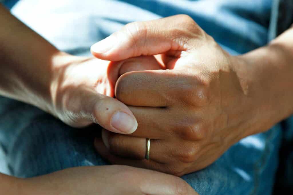 an image of two people holding hands in a depression treatment center