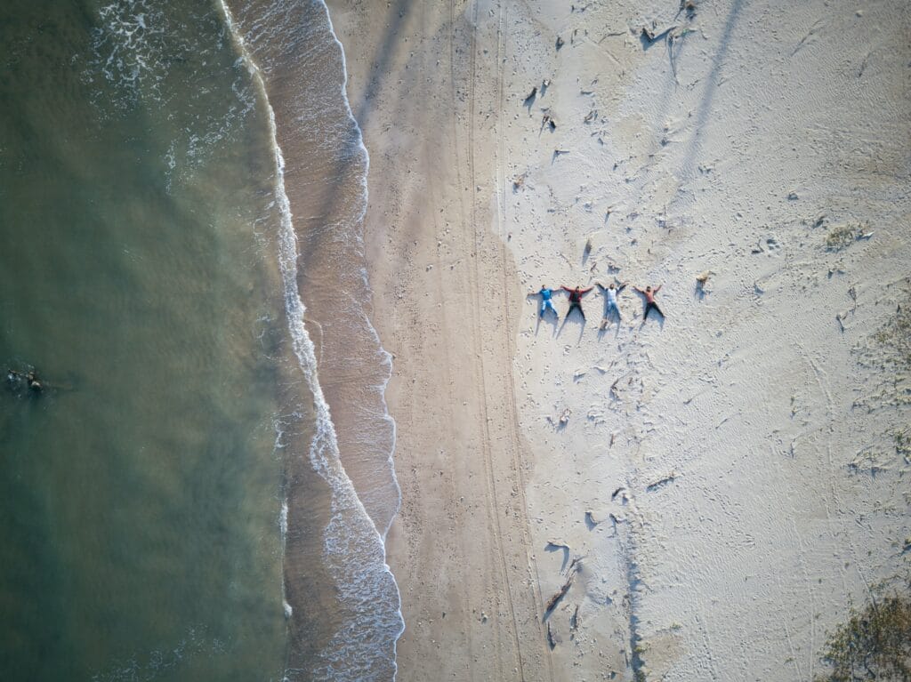 An image of people on a beach near an alcohol rehab corona