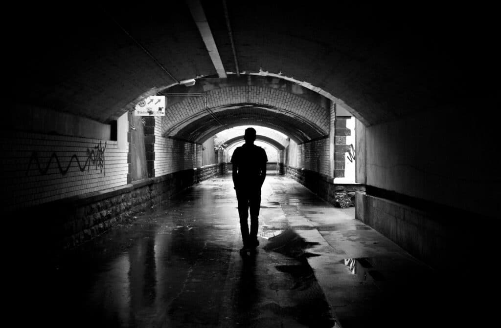 An image of a man in a tunnel | Stages of relapse
