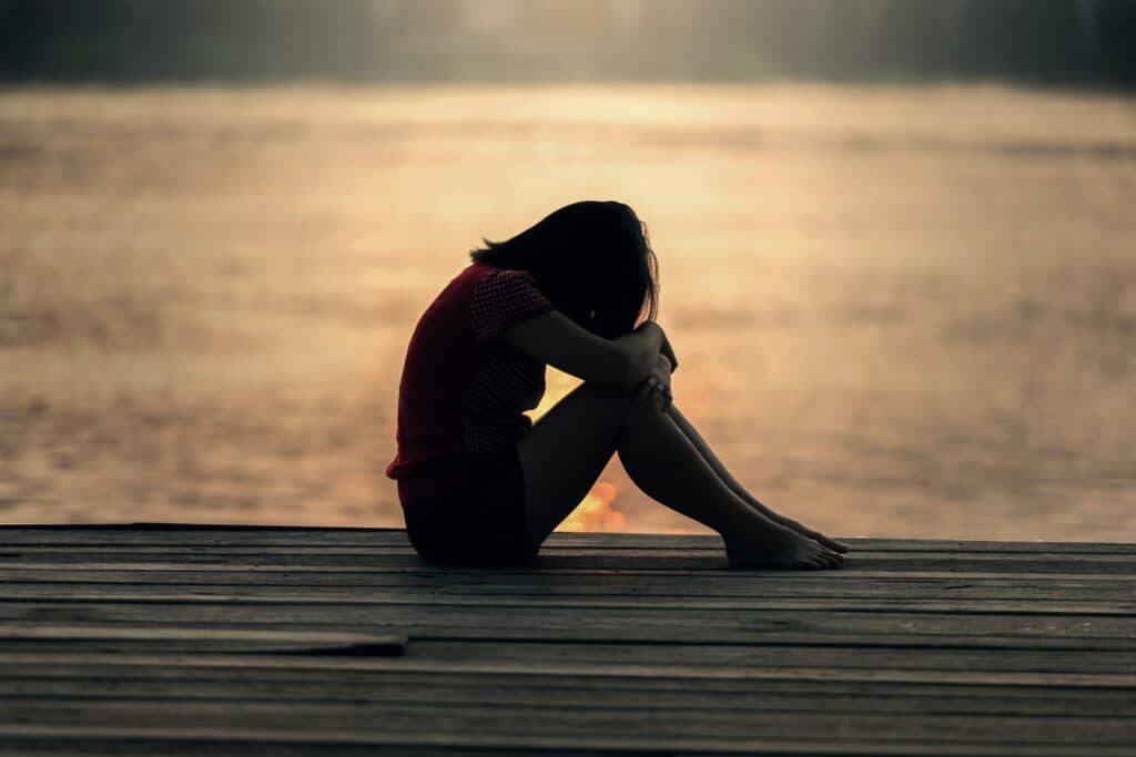 An image of a woman grieving | grief and addiction