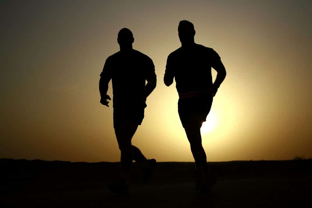 An image of two men running and learning how to stay sober