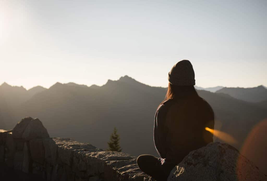 An image of a person partaking in positive self-talk on a mountain