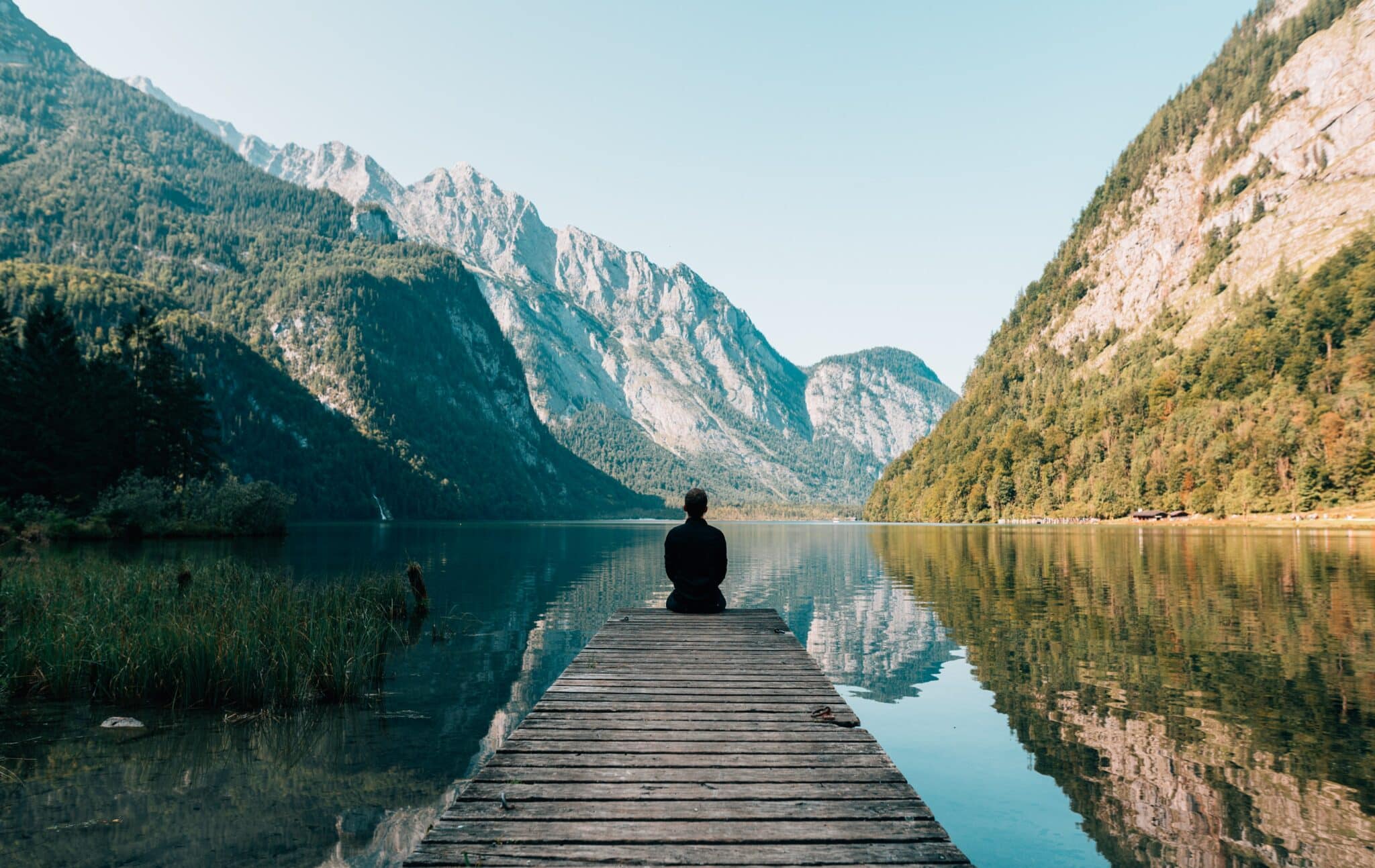 An image of a person on a dock on a lake | Mental Health Benefits of Being Outdoors