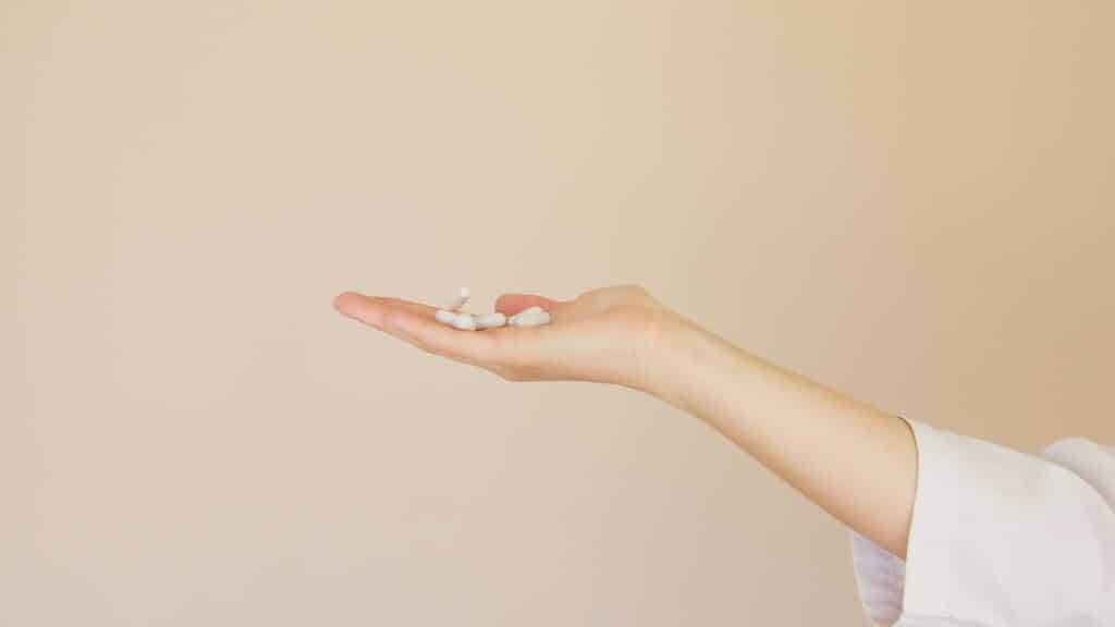 An image of a woman holding painkillers | Painkiller Addiction