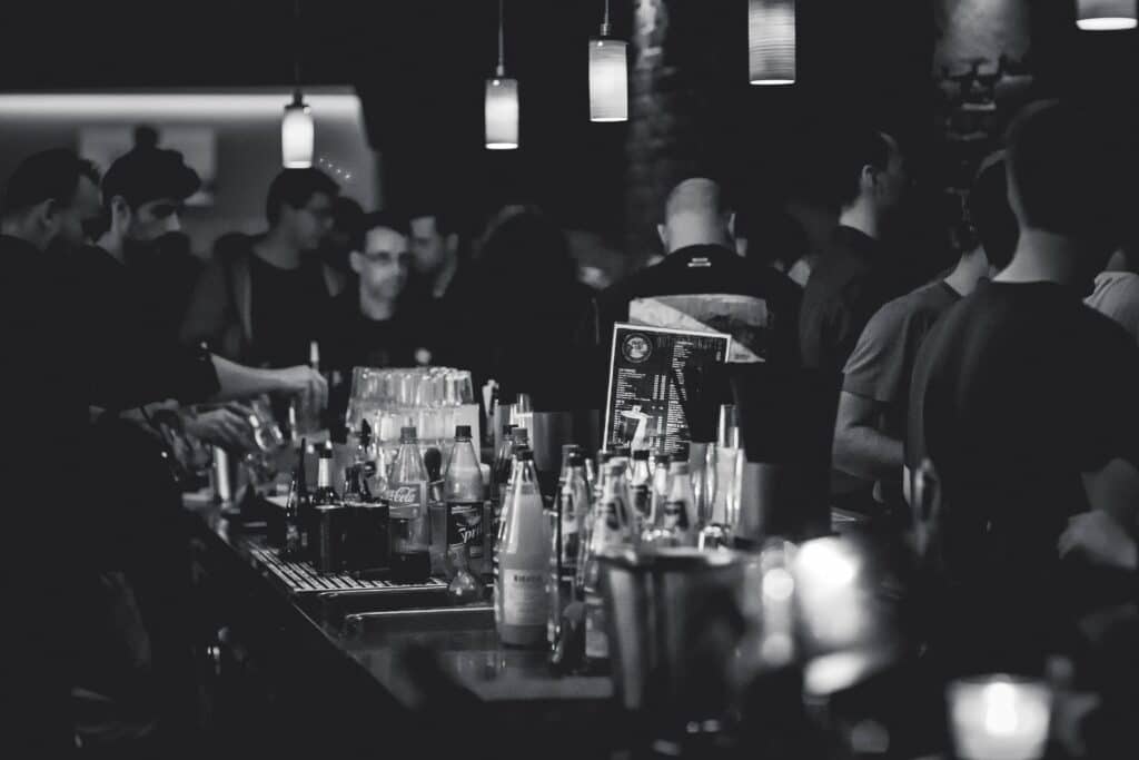 An image of people at a bar mixing Zoloft and alcohol