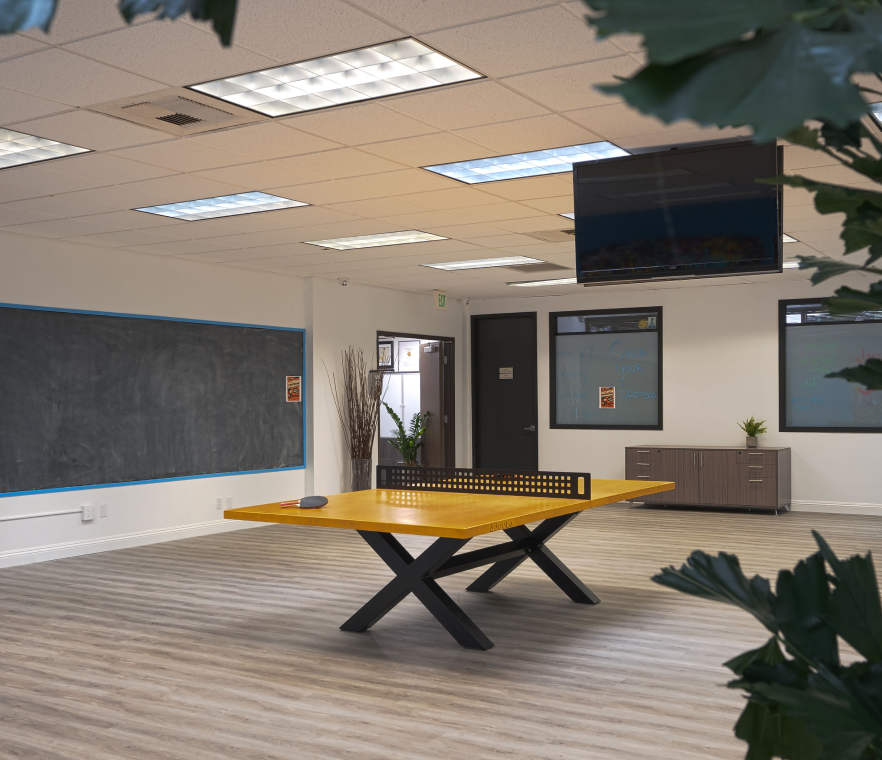 Office room with a table tennis table in the center of it and alone