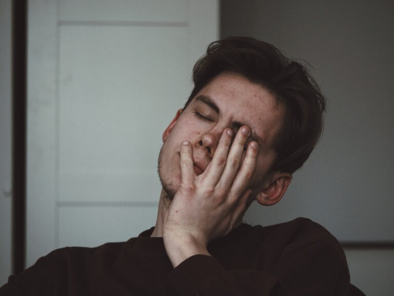an image of a man with his hand on his face to represent klonopin addiction symptoms.