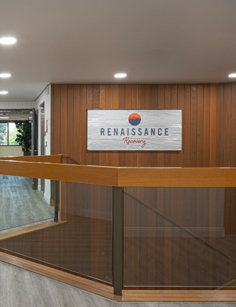 renaissance recovery facility with a sign next to the stairs
