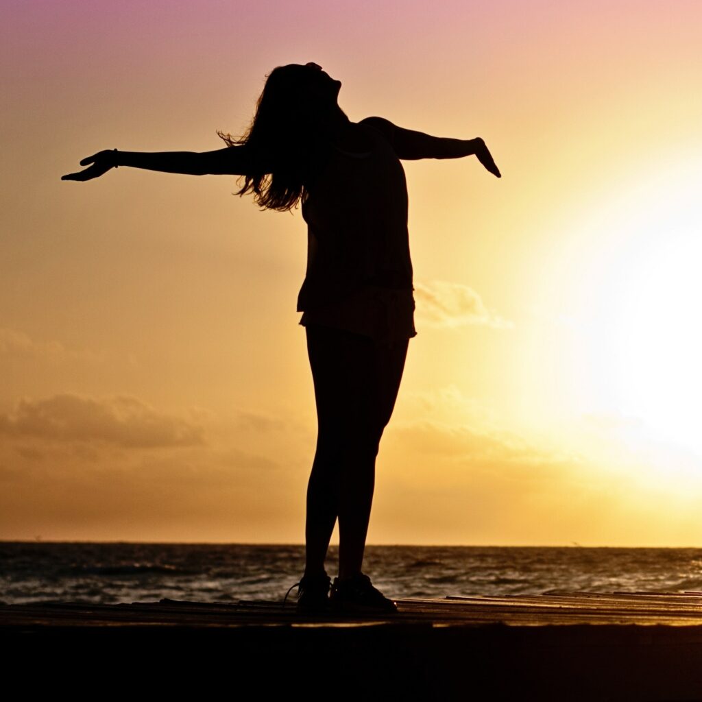 a woman stands at sunset to represent prescription drug rehab centers in california.