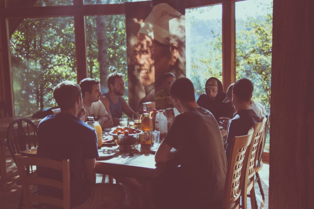group of people all having a meal together while sitting around a table