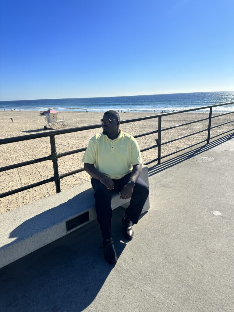 man sitting on a bench at the beach