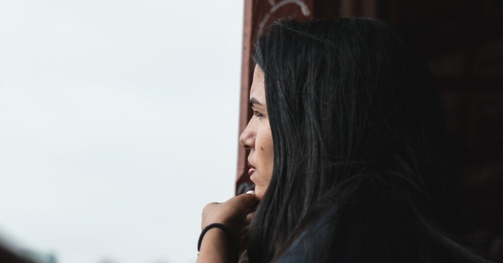 woman staring out of a window representing overdosing on cocaine