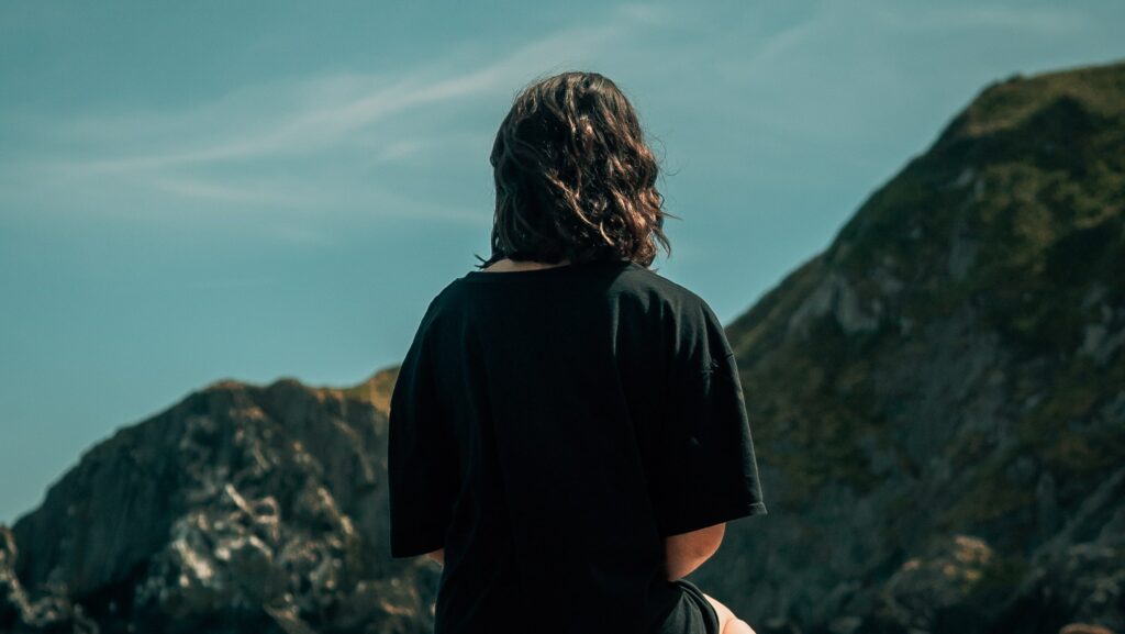 back view of a woman staring off into the mountain representing Alcohol and cancer risk
