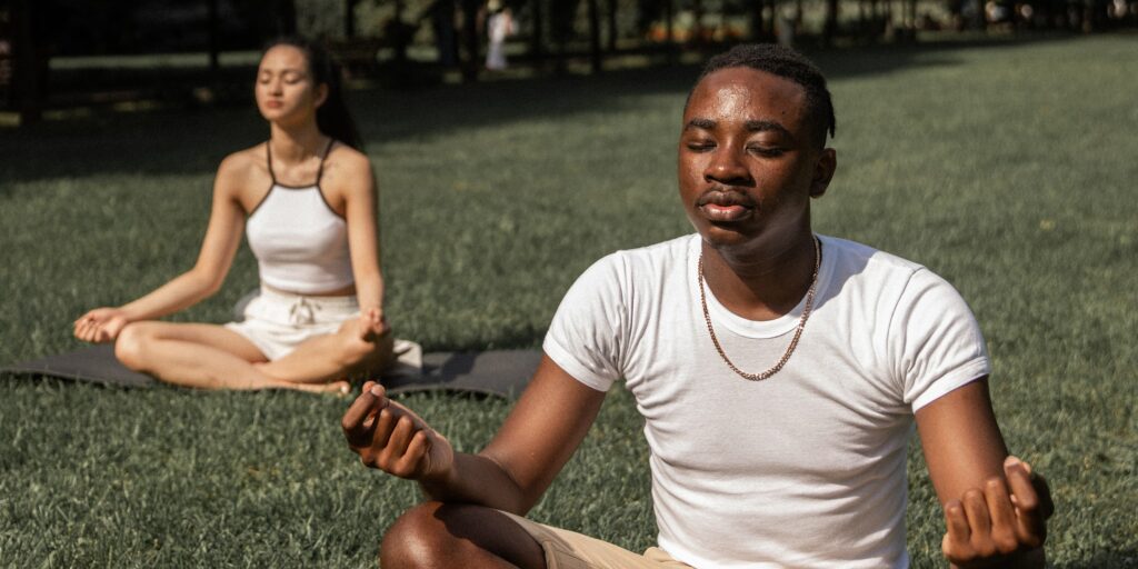 Two people practicing types of breathwork. 