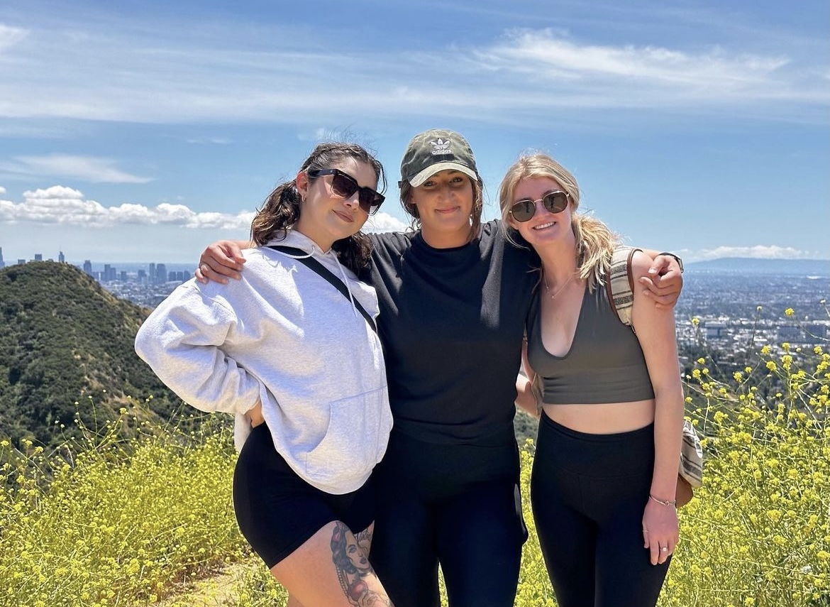 3 women posing together on a hike