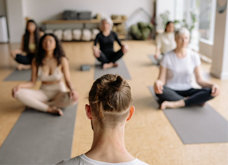 group doing yoga in a yoga studio