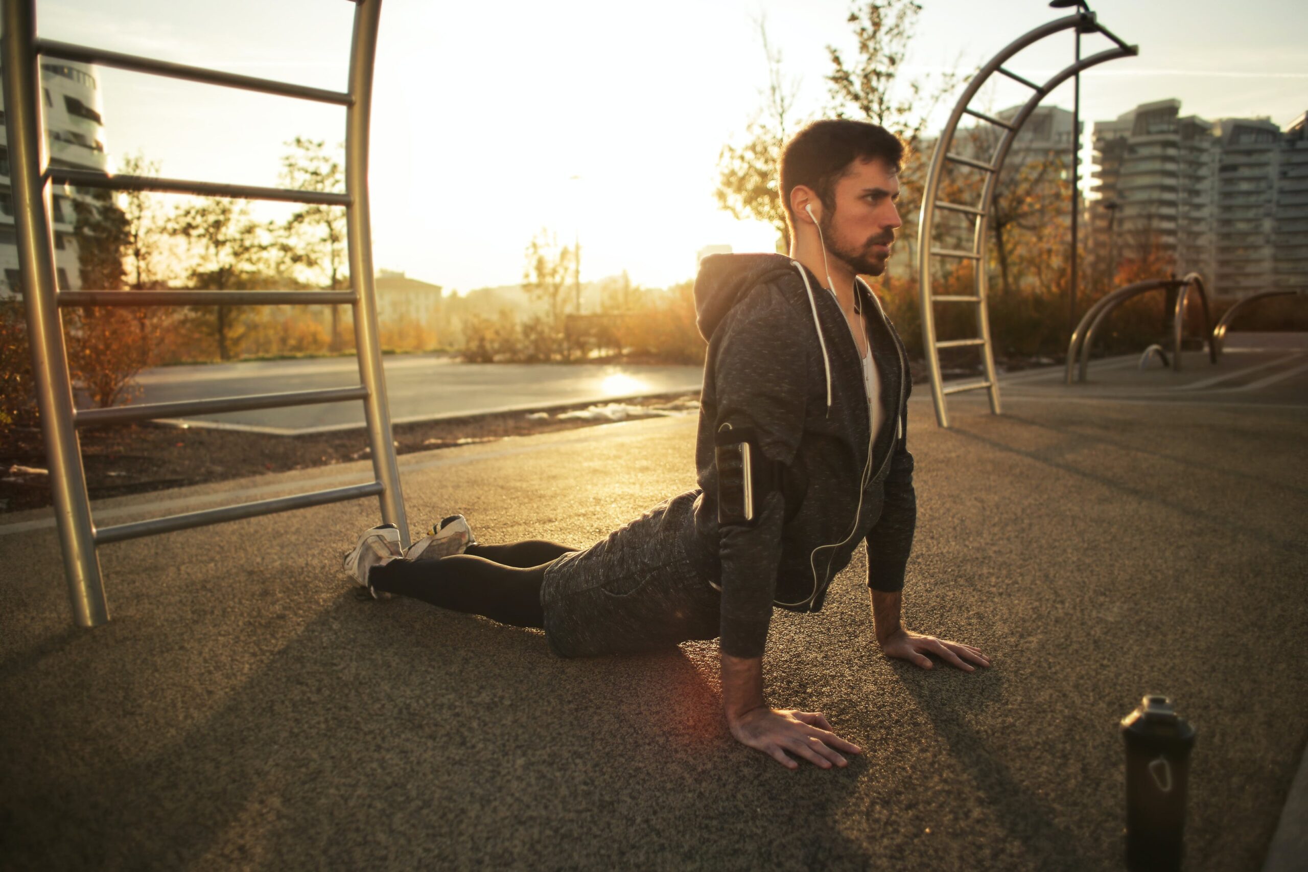 A man does yoga during a morning exercise, showing the importance of fitness therapy for addiction recovery