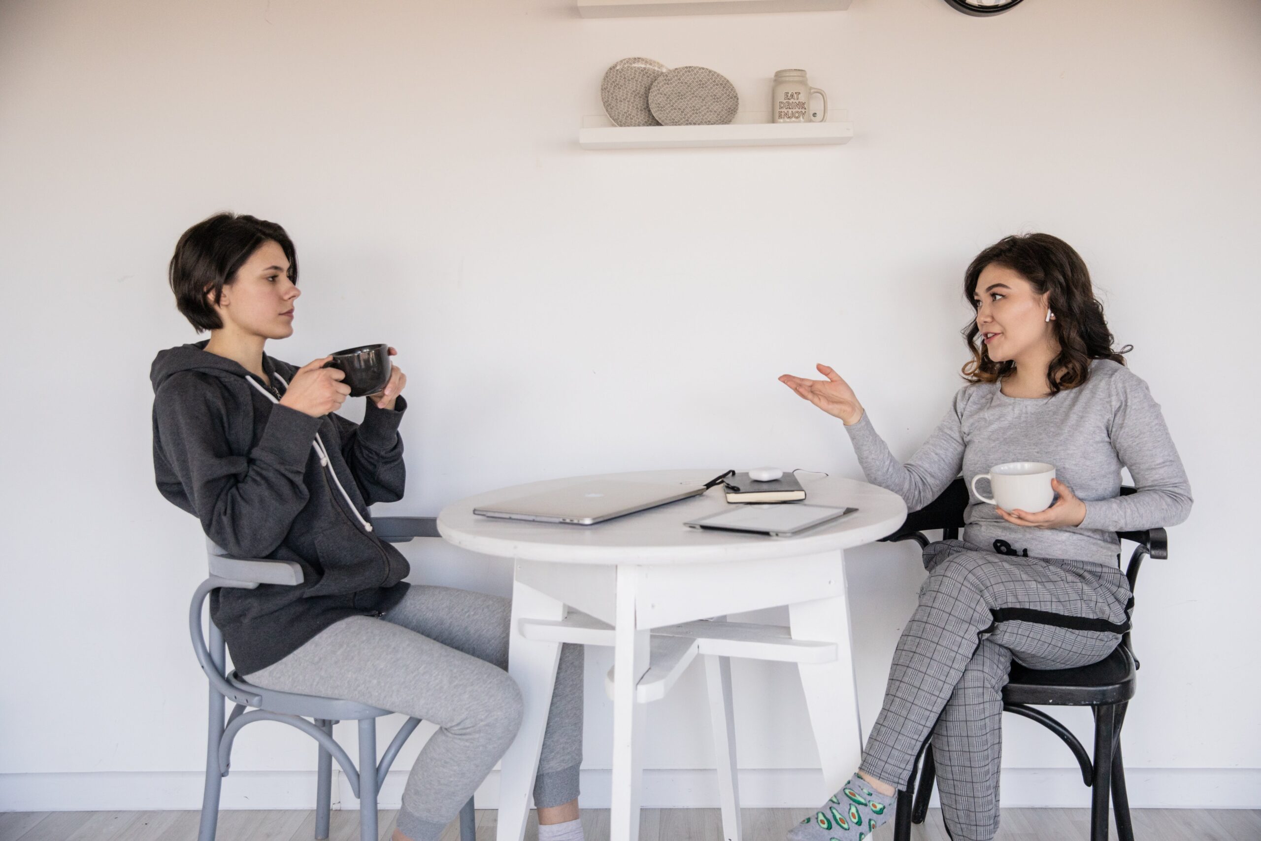 Two women talk over coffee, highlighting the importance of Communication skills in addiction recovery