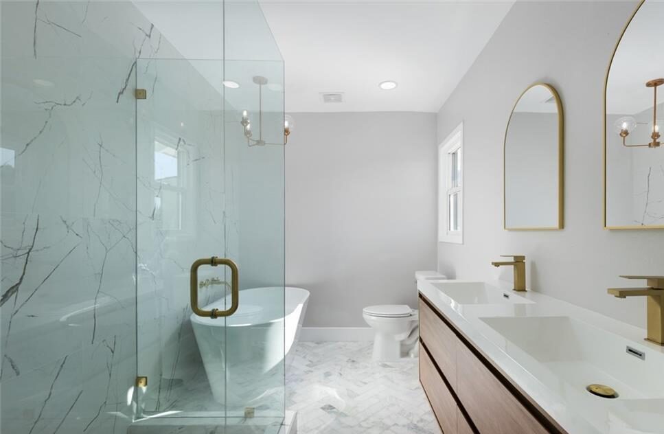 Bathroom with a clear shower and bathtub in the middle