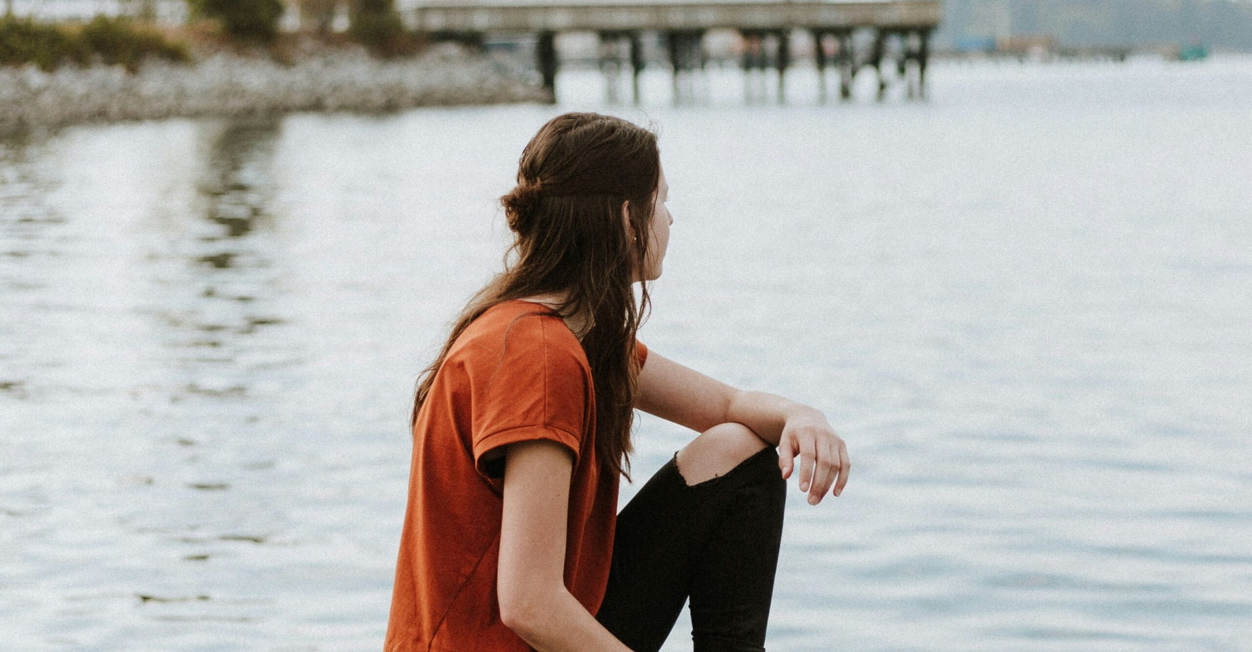 woman looking out at a lake representing alcohol and stroke risk